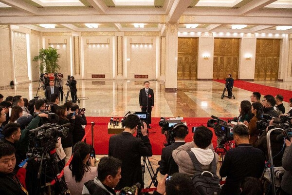 Chinese ministers are interviewed after the opening meeting of the second session of the 14th National People's Congress at the Great Hall of the People, Beijing, March 5. (Photo by Weng Qiyu/People's Daily Online)