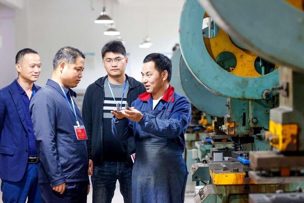 A deputy to the People's Congress of Shuibian township, Xiajiang county, Ji'an, east China's Jiangxi province learns about the production and operation situation of a local enterprise. (Photo by Chen Fuping/People's Daily Online)