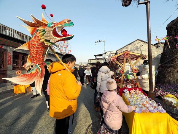 Tourists shop in the Moshikou historical and cultural block in Shijingshan district, Beijing for the Lantern Festival, Feb. 24, 2024. (Photo by Du Jianpo/People's Daily Online)