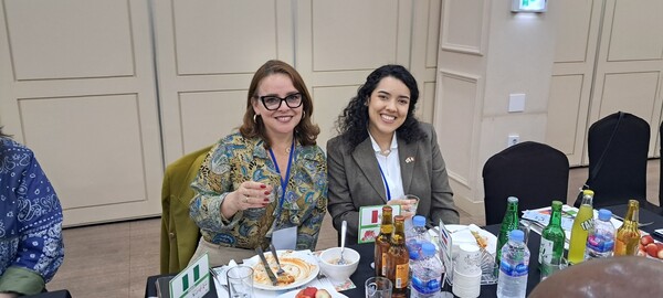 Mrs. Jeanette Somocurcio (spouse of the ambassador of Peru poses with an Embassy member.