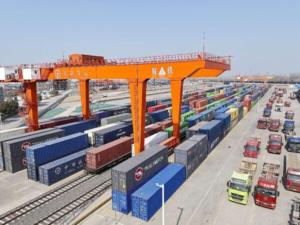 Containers are piled in a distribution center of an international railway port in Xuzhou, east China's Jiangsu province, March 12, 2024. (Photo by Sun Jingxian/People's Daily Online)