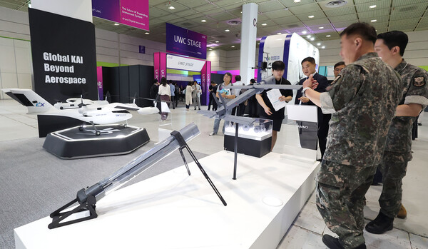 A military official inspects a launch-capable drone during a demonstration. (Source: Yonhap News)
