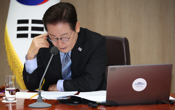 President Lee Jae-myung listens to remarks during a meeting. (Source: Yonhap News)
