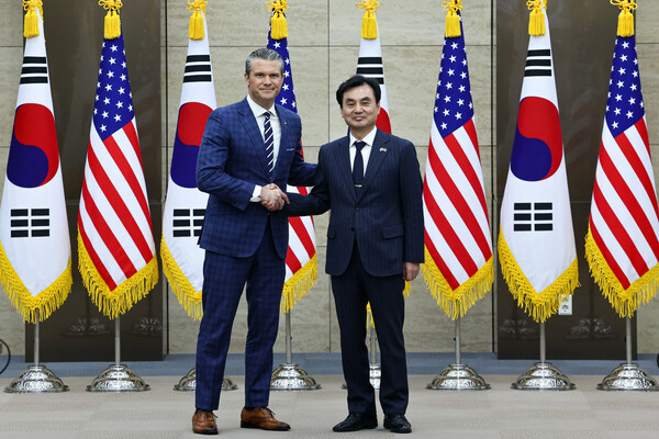U.S. and South Korean defense chiefs shake hands during the expanded SCM session. (Source: Yonhap News)